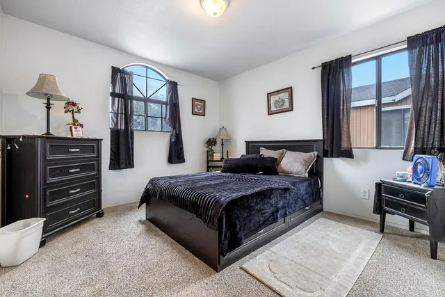 a living room with a bed furniture and a window