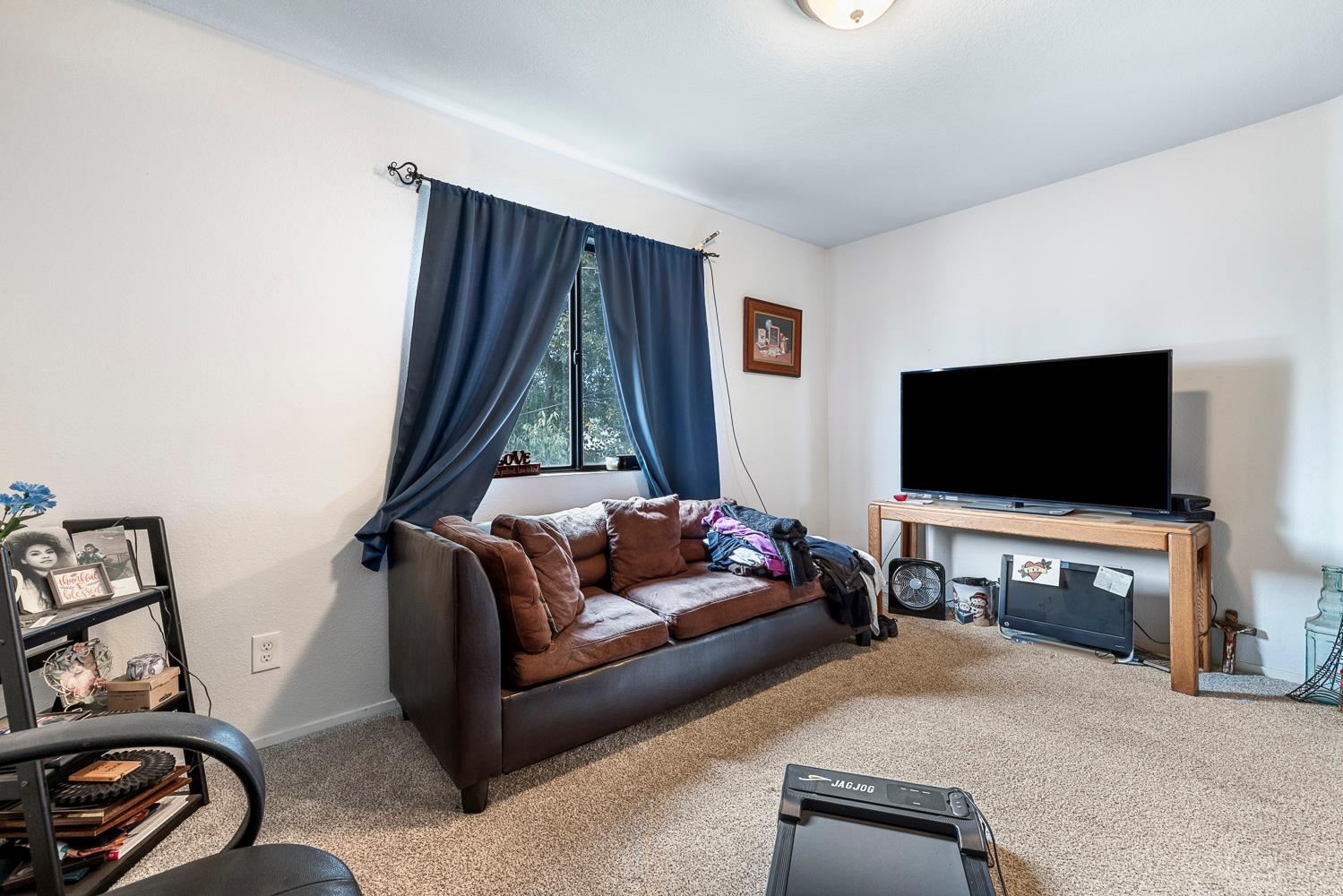 1592 North Ferger Avenue Fresno, CA 93728 - Photo 22 of 30 a living room with furniture and a flat screen tv