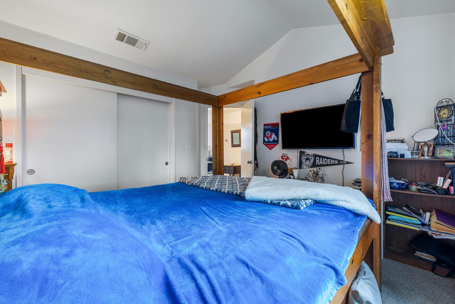 1592 North Ferger Avenue Fresno, CA 93728 - Photo 25 of 30 a bed room with a bed tv and a television