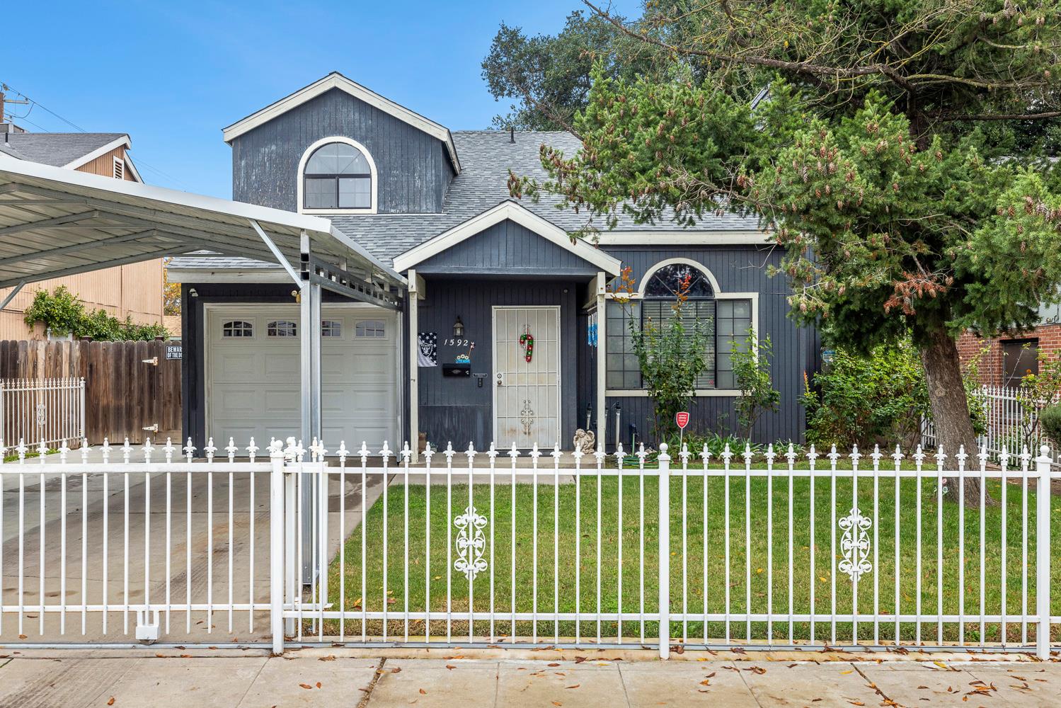 1592 North Ferger Avenue Fresno, CA 93728 - Photo 3 of 30 a front view of a house with a garden