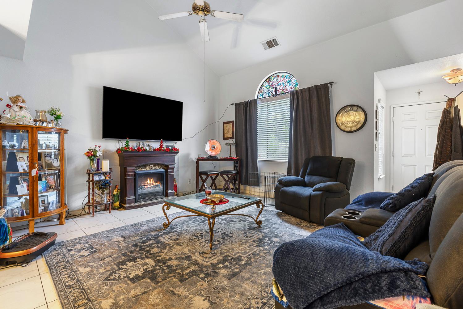 1592 North Ferger Avenue Fresno, CA 93728 - Photo 8 of 30 a living room with furniture a fireplace and a flat screen tv