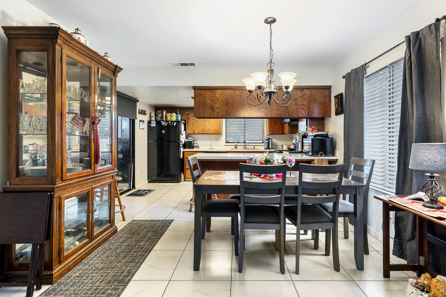 1592 North Ferger Avenue Fresno, CA 93728 - Photo 10 of 30 a view of a dining room with furniture window and wooden floor