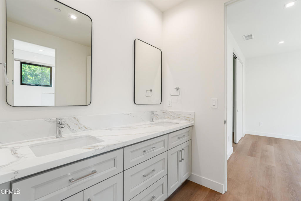 2821 Los Robles Road Thousand Oaks, CA 91362 - Photo 30 of 68 a bathroom with a double vanity sink and mirror