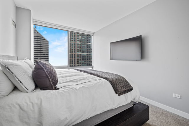 8 East Randolph Street, Unit 3004 Chicago, IL 60601 - Photo 11 of 20 a bedroom with a bed and window