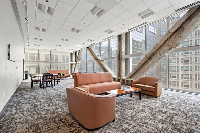 a living room with furniture and a dining table