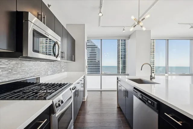 a kitchen with a sink stove top oven and cabinets
