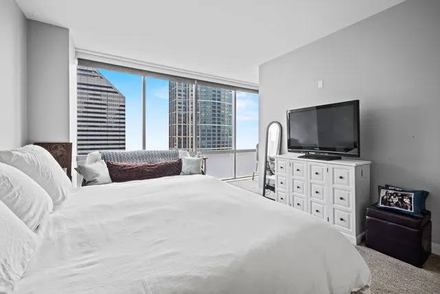 a bedroom with a flat screen television and a bed