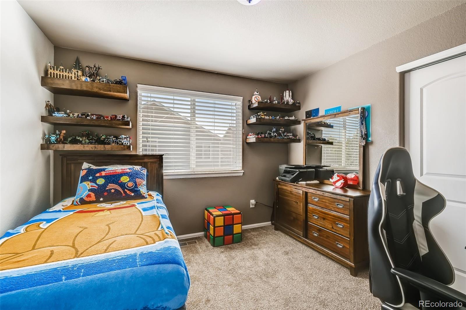 465 Territory Lane Johnstown, CO 80534 - Photo 12 of 24 a bed room with a bed furniture and a window