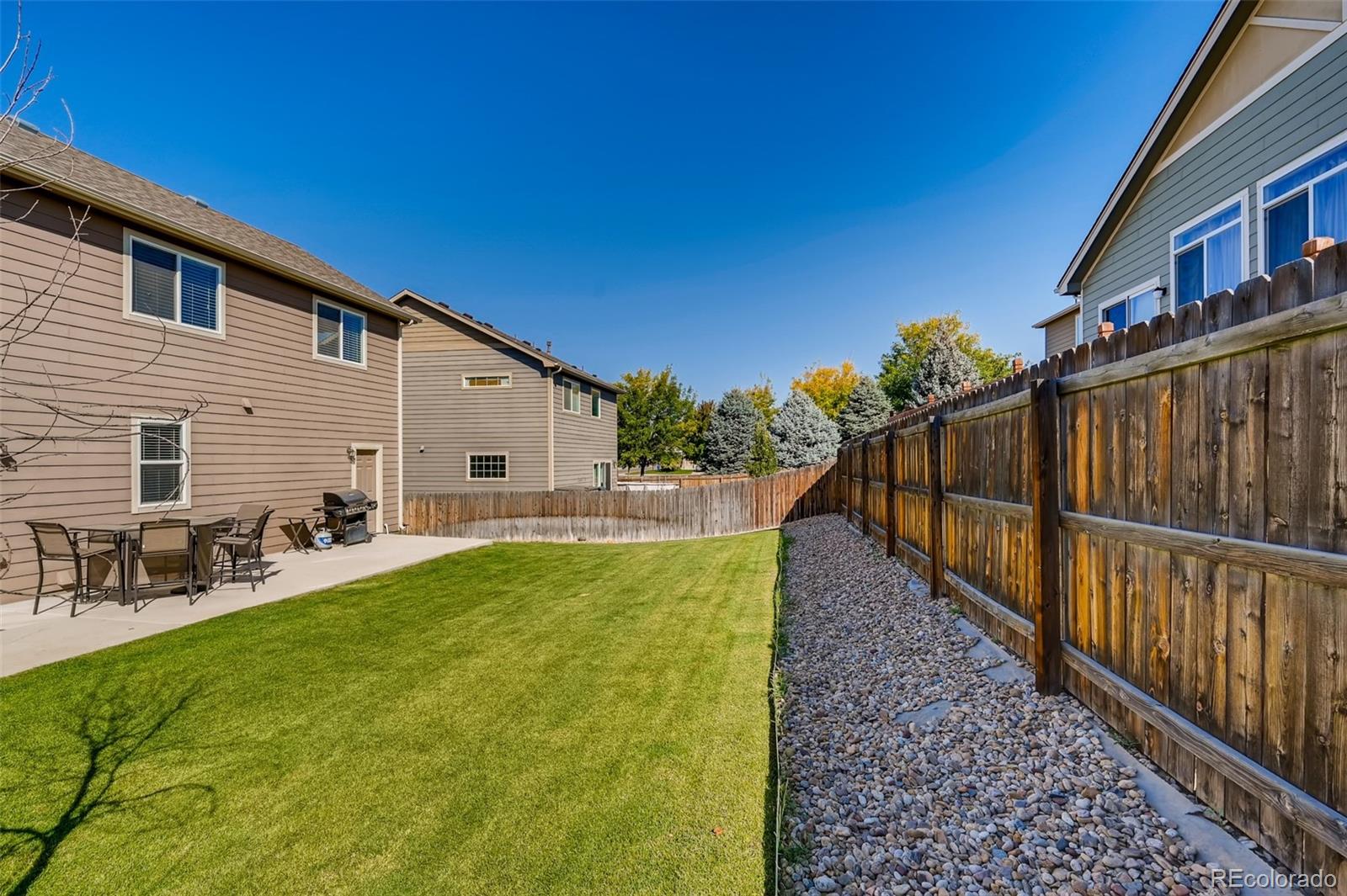 465 Territory Lane Johnstown, CO 80534 - Photo 19 of 24 a view of a house with backyard and sitting area