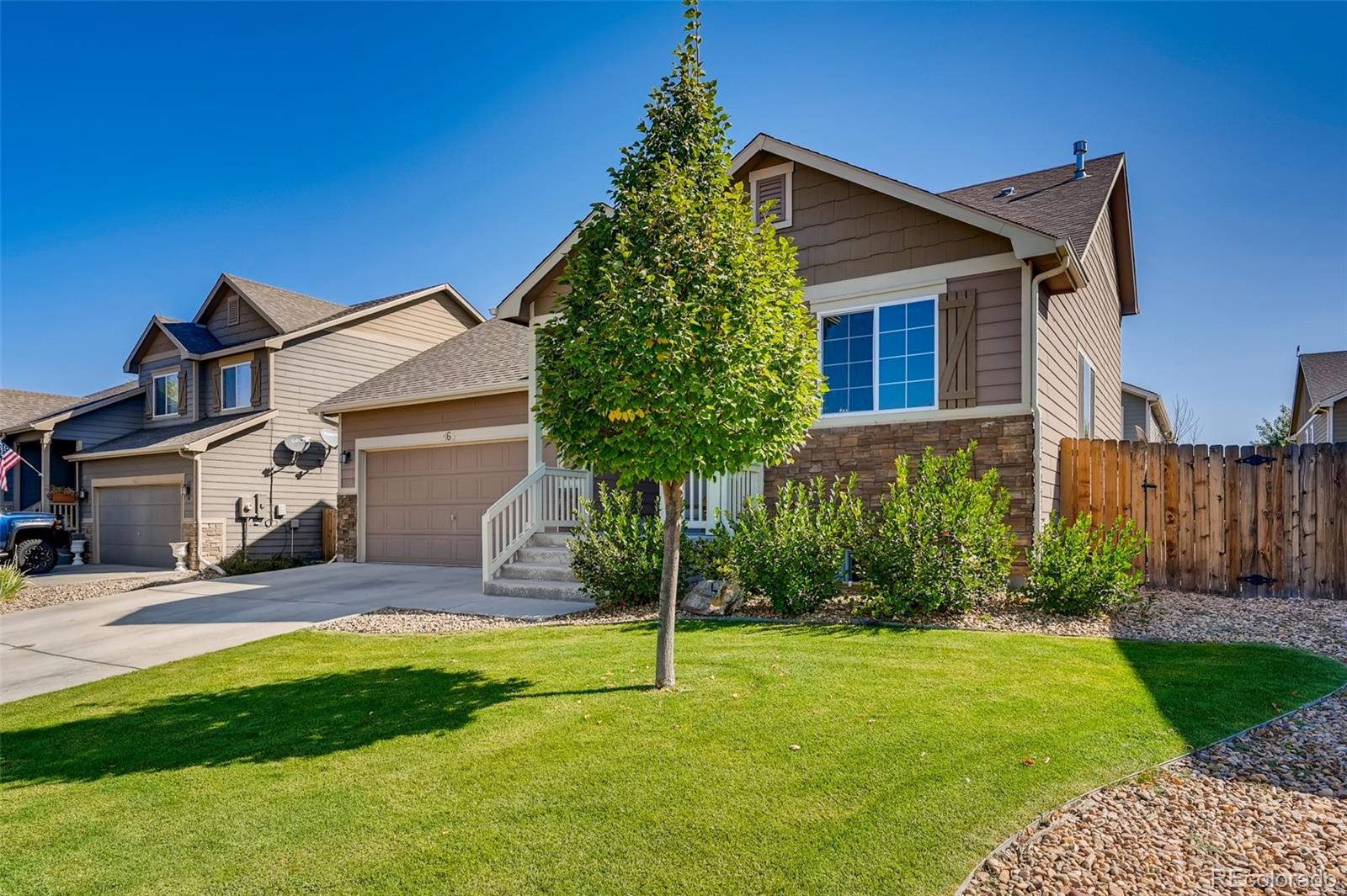 465 Territory Lane Johnstown, CO 80534 - Photo 2 of 24 a front view of a house with a yard