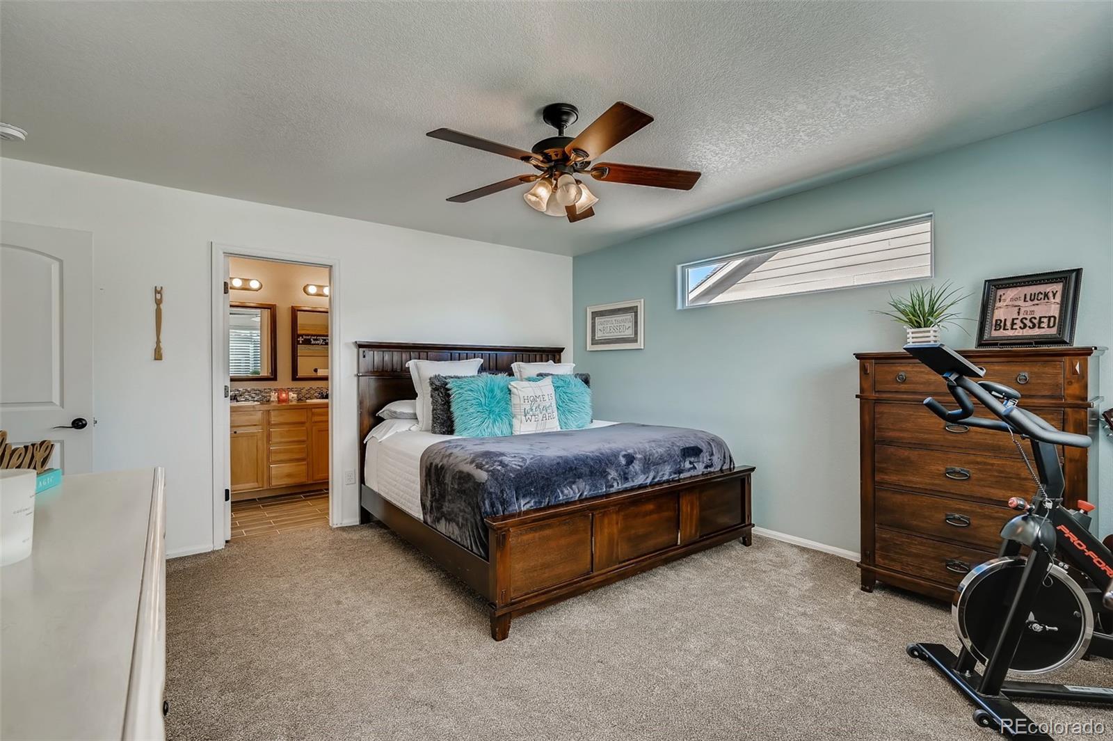 465 Territory Lane Johnstown, CO 80534 - Photo 9 of 24 a bedroom with a bed and a ceiling fan