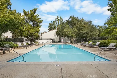 a view of a swimming pool with lounge chairs