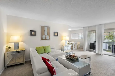 a living room with furniture and a lamp