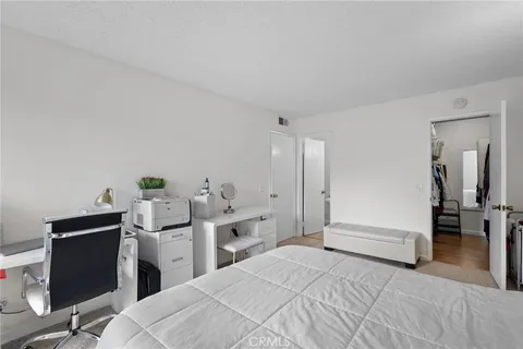 a bedroom with a bed and a desk