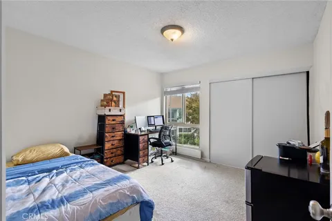 a bedroom with a bed and a desk