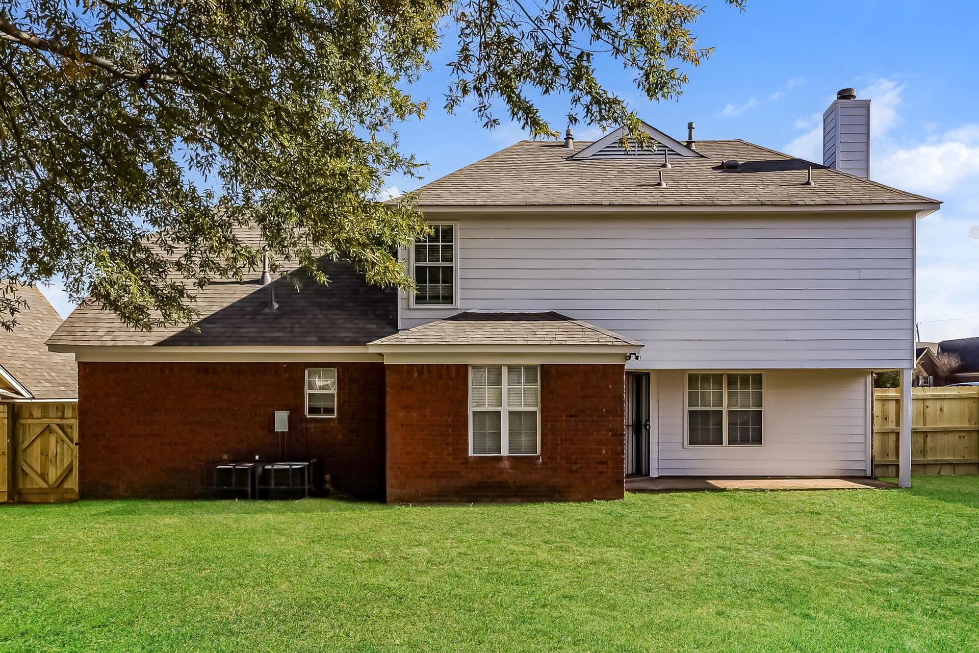 5377 Ragan Ridge Drive Memphis, TN 38141 - Photo 15 of 17 a front view of a house with a garden
