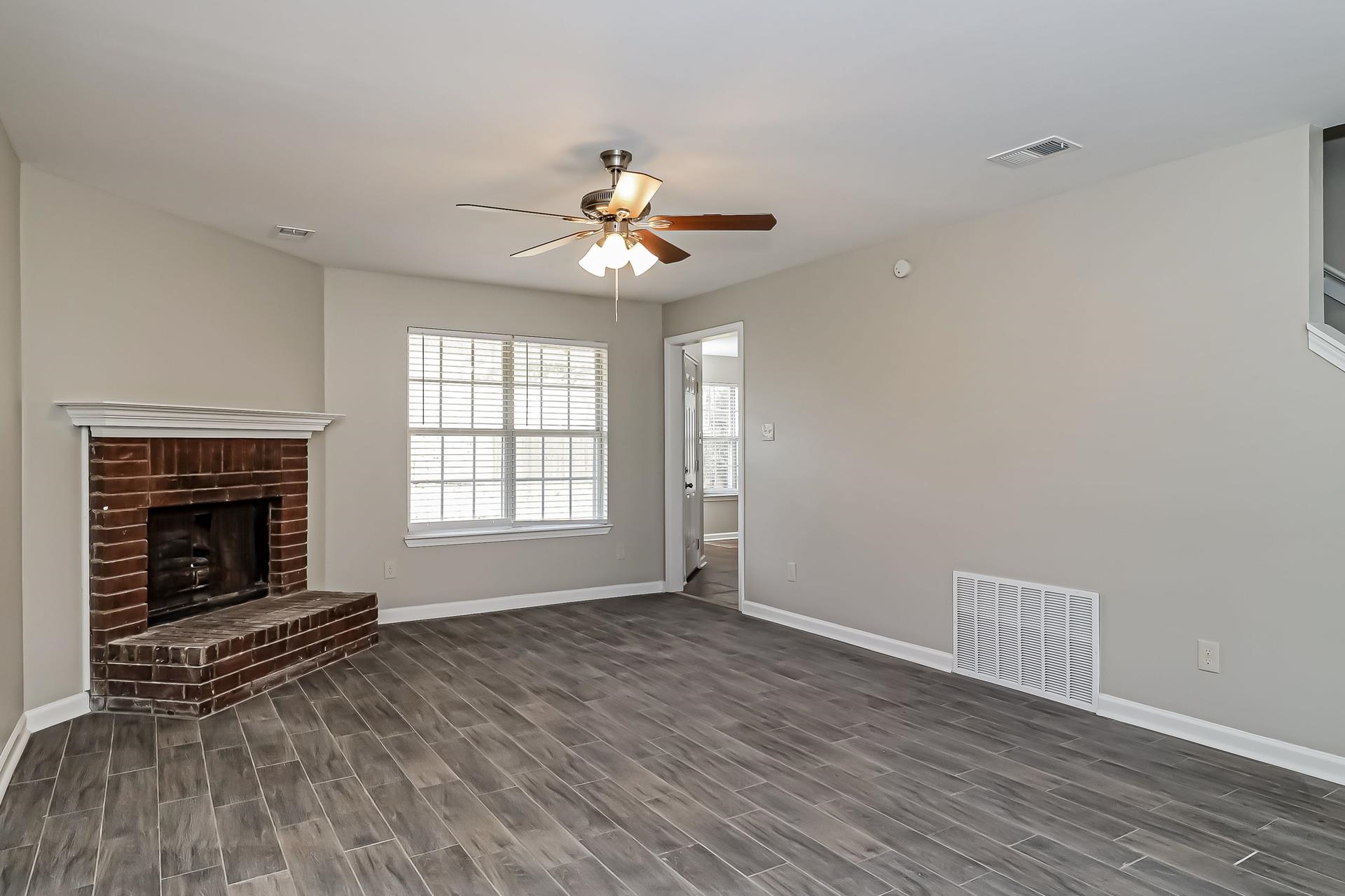 5377 Ragan Ridge Drive Memphis, TN 38141 - Photo 3 of 17 wooden floor in an empty room with a window