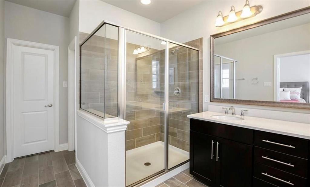 a bathroom with a shower sink and mirror
