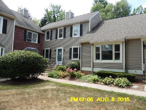 7 Braintree Court, Unit 7 Suffield, CT 06078 - Photo 1 of 1 a front view of a house with a yard and a garden