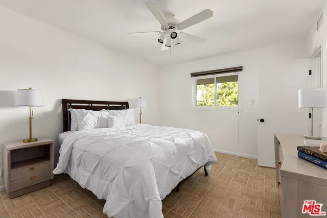 a bedroom with bed and a chandelier