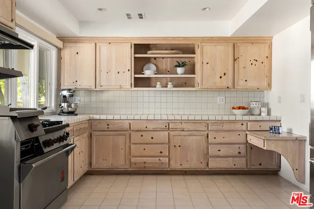 a kitchen with granite countertop white cabinets and stainless steel appliances