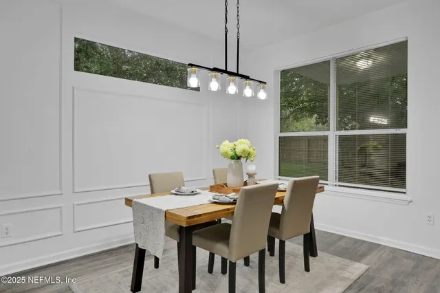 a view of a dining room with furniture and chandelier
