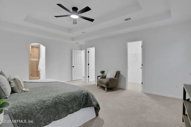 a spacious bedroom with a bed and furniture