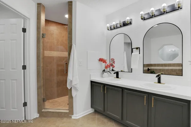 a bathroom with a double vanity sink and a mirror