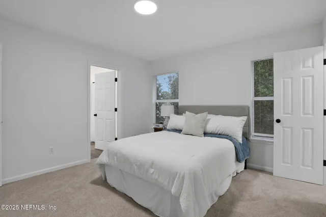 a bedroom with a bed and a night stand