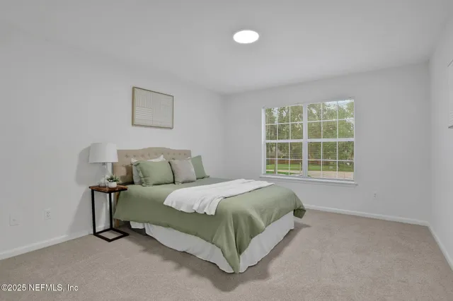 a bed sitting in a bedroom next to a window