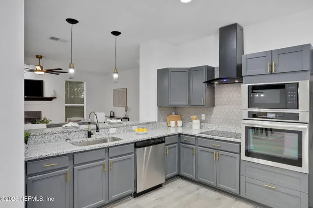 a kitchen with a sink cabinets and appliances