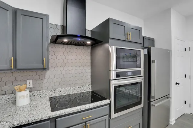 a kitchen with granite countertop stainless steel appliances and counter space