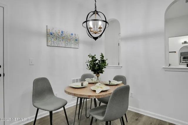 a view of a dining room with furniture and wooden floor
