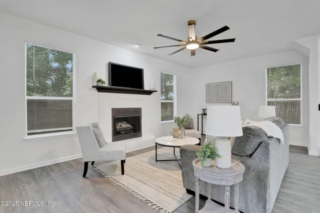 a living room with furniture a fireplace and a flat screen tv
