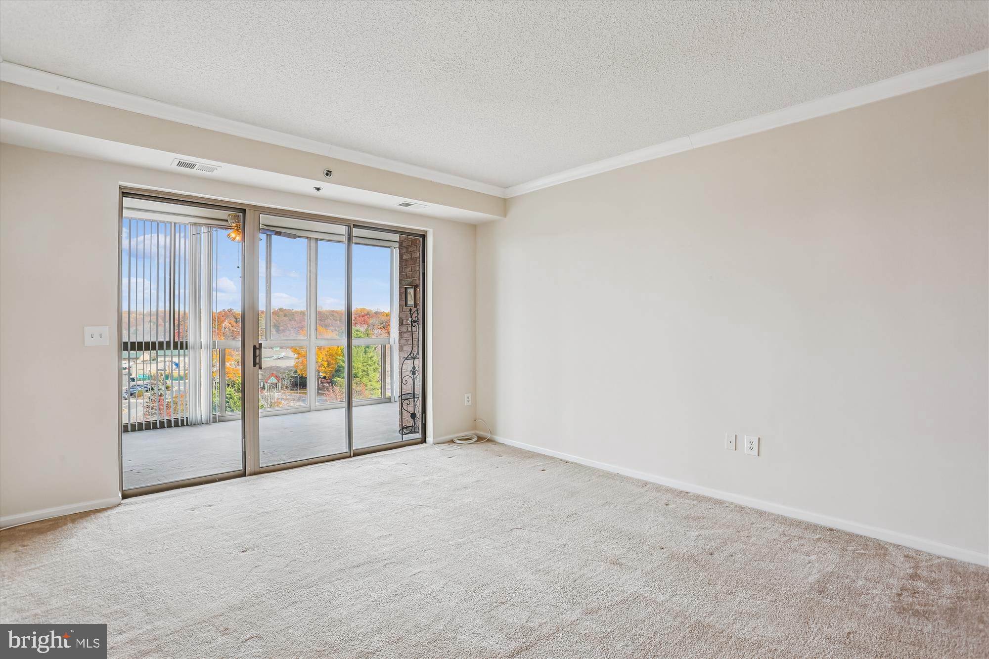 3210 North Leisure World Boulevard, Unit 610 Silver Spring, MD 20906 - Photo 19 of 97 a view of an empty room with wooden floor and a window