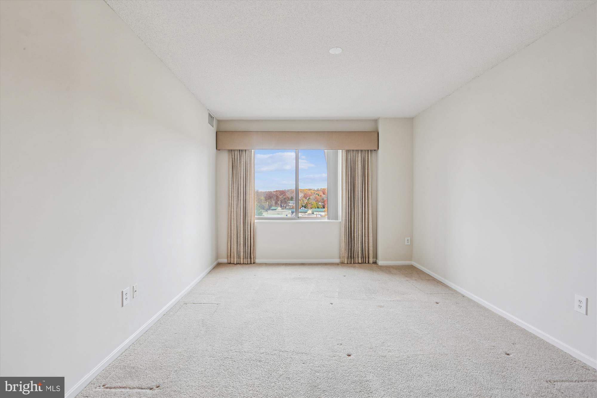 3210 North Leisure World Boulevard, Unit 610 Silver Spring, MD 20906 - Photo 31 of 97 a view of an empty room with a window