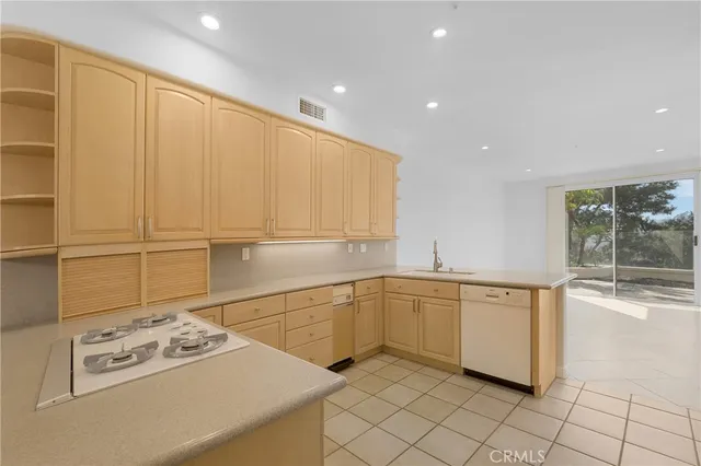 a kitchen with stainless steel appliances granite countertop a sink and cabinets
