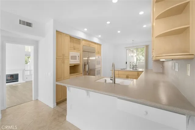 a view of a kitchen with kitchen island a sink and a large window