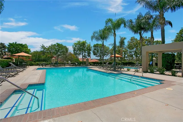 a view of swimming pool with outdoor seating and a garden