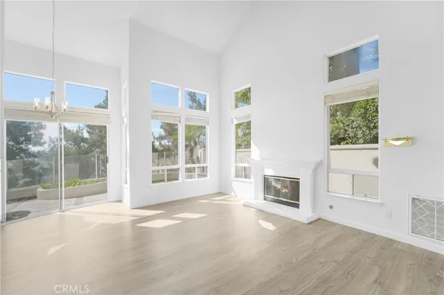 a living room with a fireplace and windows