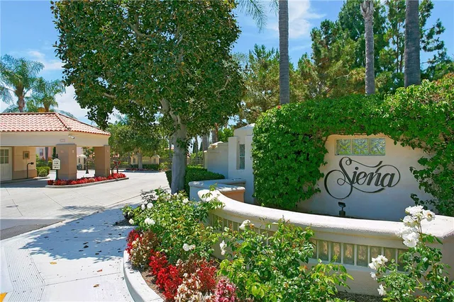 a sign that is sitting in front of flowers