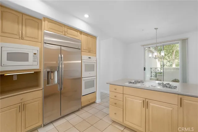 a kitchen with stainless steel appliances a refrigerator sink and cabinets