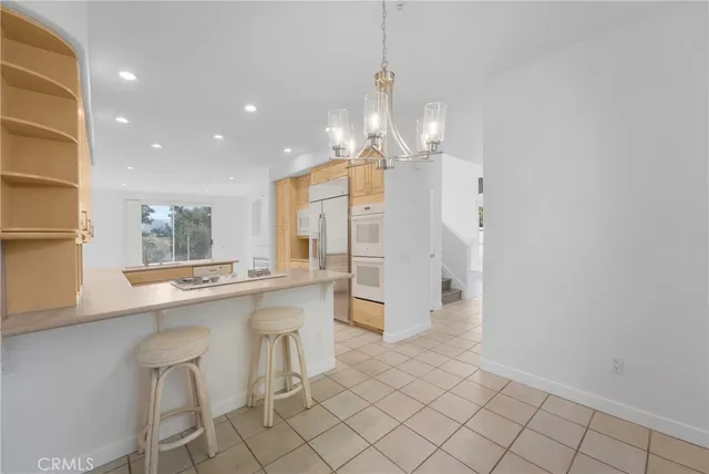 a kitchen with stainless steel appliances granite countertop a sink and a refrigerator
