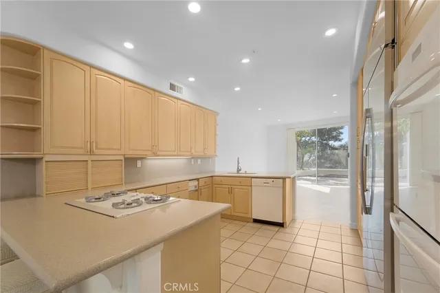 a kitchen with a sink cabinets and appliances