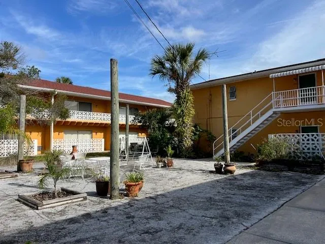 a view of a house with backyard porch and sitting area