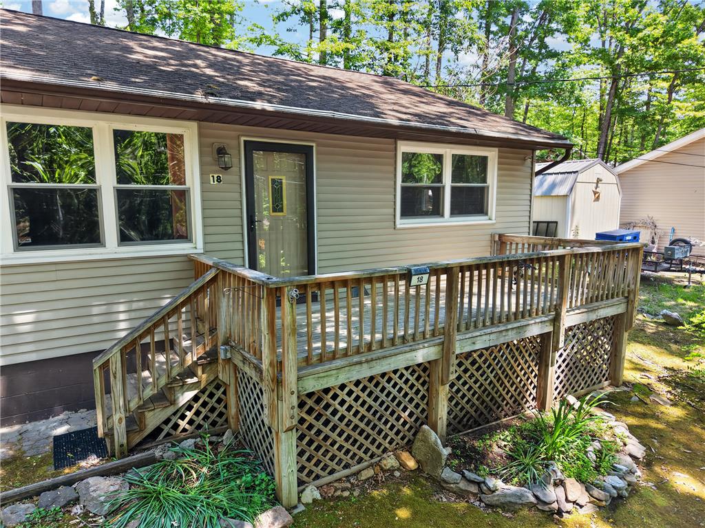 18 White Oak Road Nesquehoning, PA 18240 - Photo 5 of 52 A welcoming front deck and stairs invite entry to this charming residence, nestled amidst verdant trees.