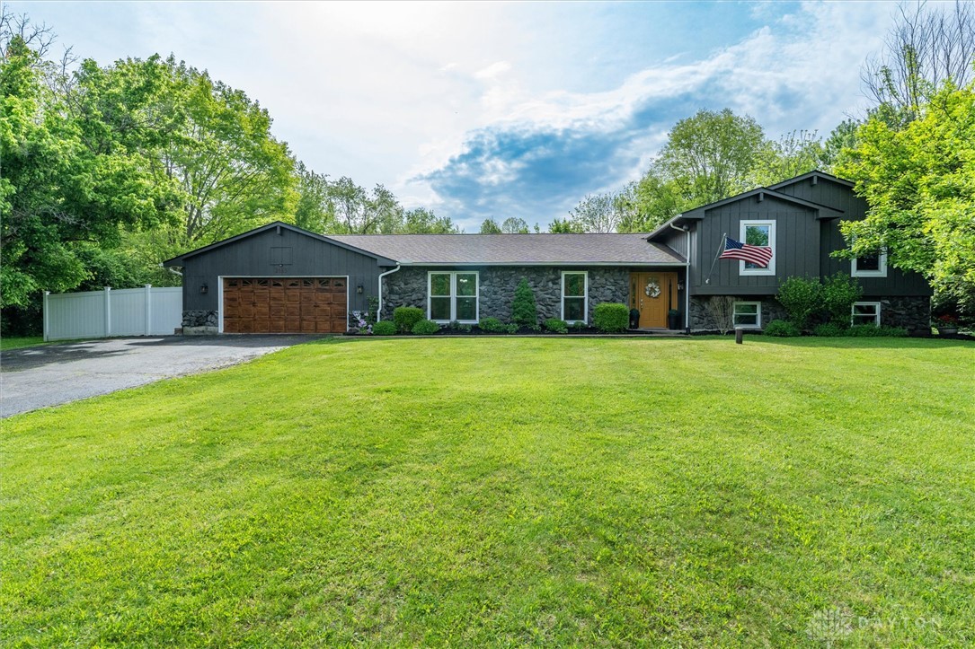 2165 Stewart Road Xenia, OH 45385 - Photo 1 of 59 This residence features a broad front yard and a charming stone and wood facade.