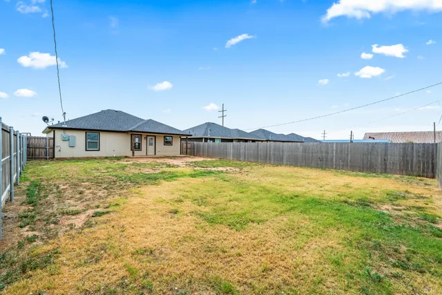a view of a house with a backyard