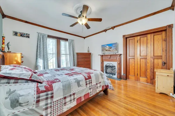 a bedroom with a bed and wooden floor