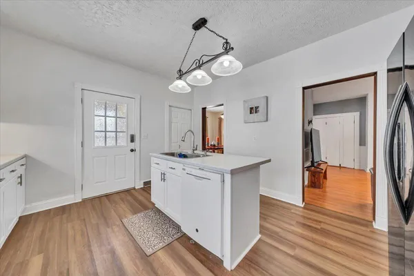 a kitchen with stainless steel appliances a refrigerator and wooden floor